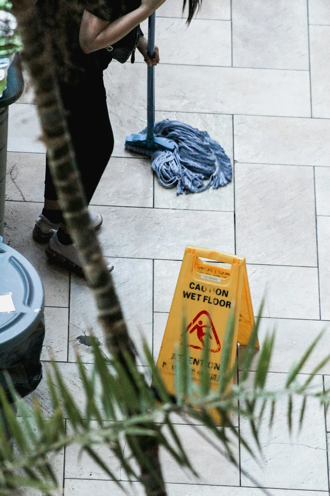 Latex gloves and spray detergent placed on table in stylish living room in daytime